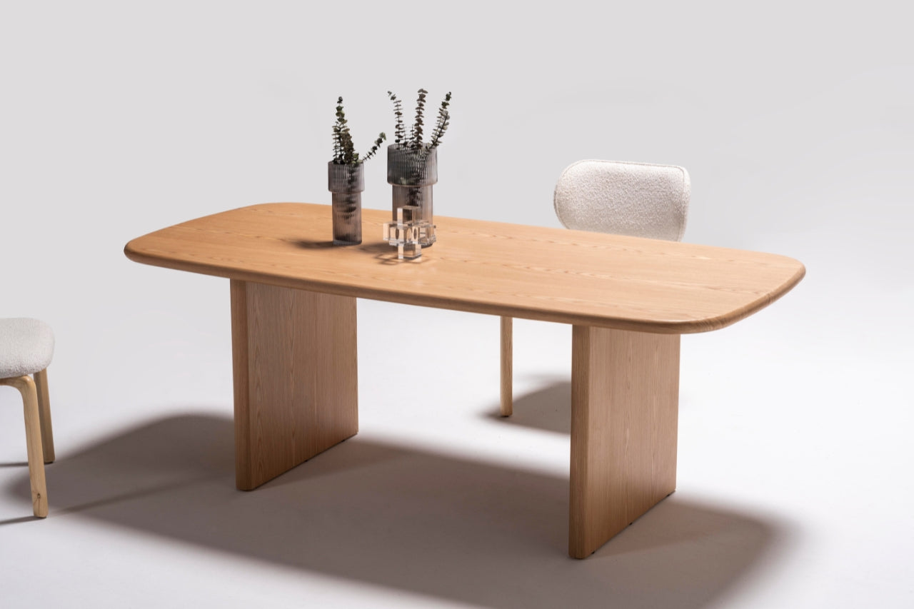 Alva Dining Table styled in a contemporary dining room with minimalist decor and pendant lighting.